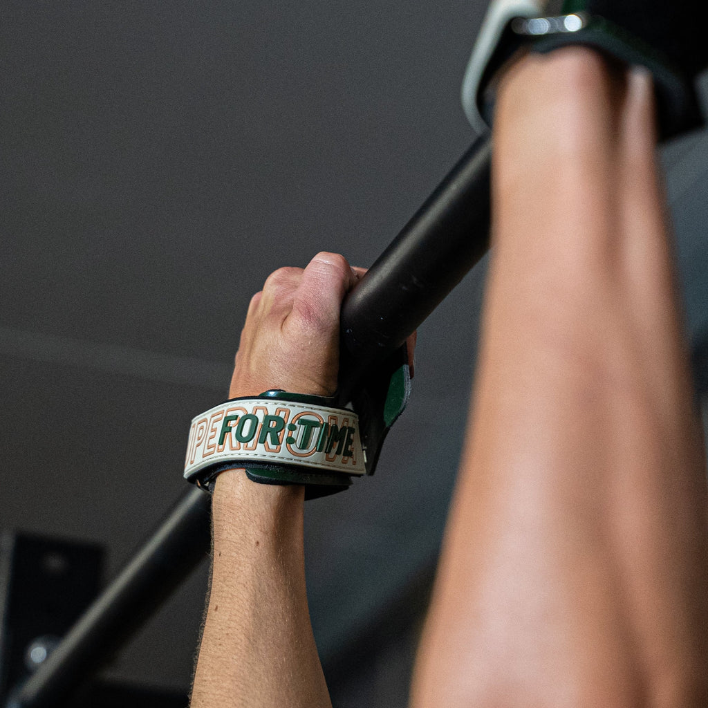 Supernova CrossFit Hand Grip are used on the Bar to perform CrossFit Gymnastics movements. Wrist strap with Logo is shown